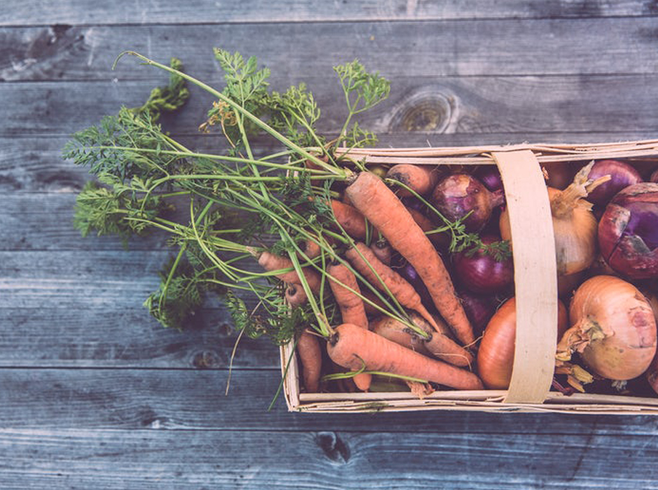carrots radishes and onions in a basket