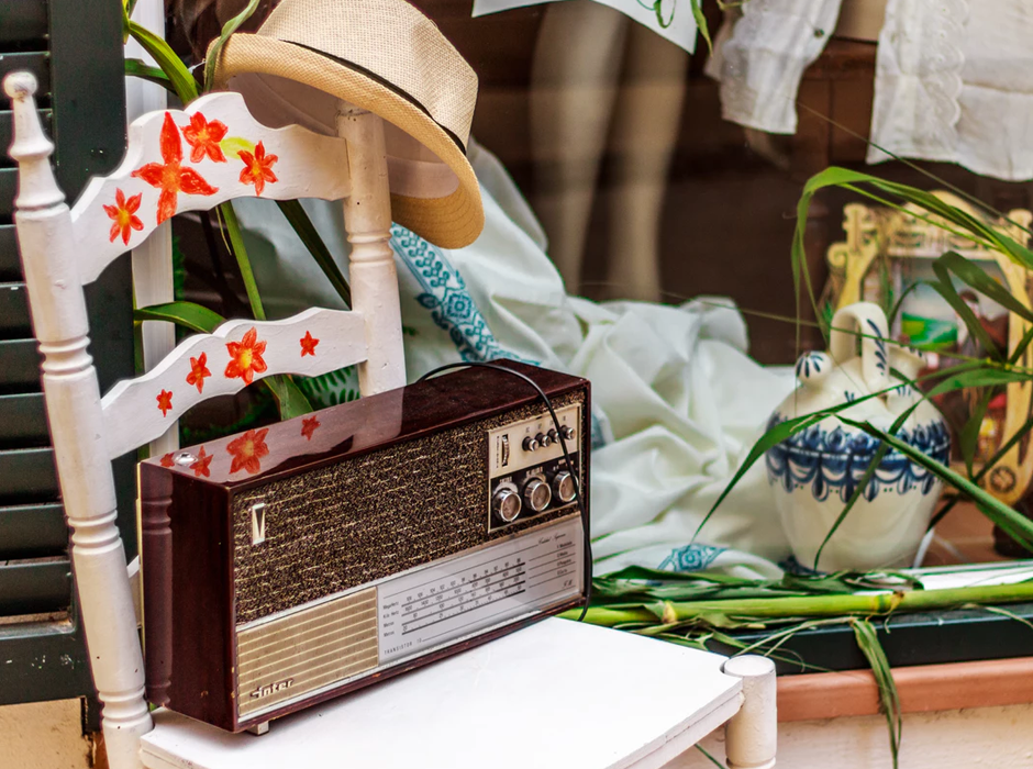 radio on a white chair with orange painted flowers